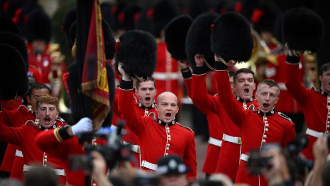 Members of the Coldstream Guards raise their Bearskin hats as they salute the new King.