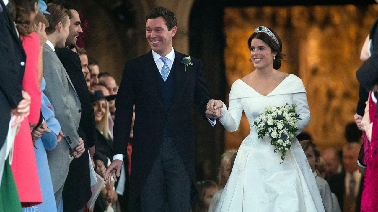 The newlyweds walking back up the aisle after saying “I do”. Photo: Steve Parsons/POOL/AFP