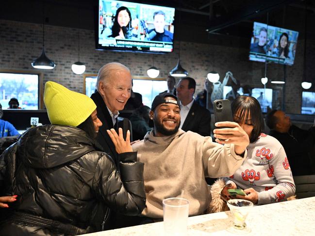 US President Joe Biden poses for a selfie with patrons at They Say restaurant in Harper Woods, Michigan, on February 1, 2024. (Photo by Mandel NGAN / AFP)