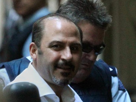 24/11/2011 NEWS: Supreme Court. Tony Mokbel looks up with a grin as he arrives alone in a prison van (with support van with armed guards one with a shotgun, standing by as he was unloaded)