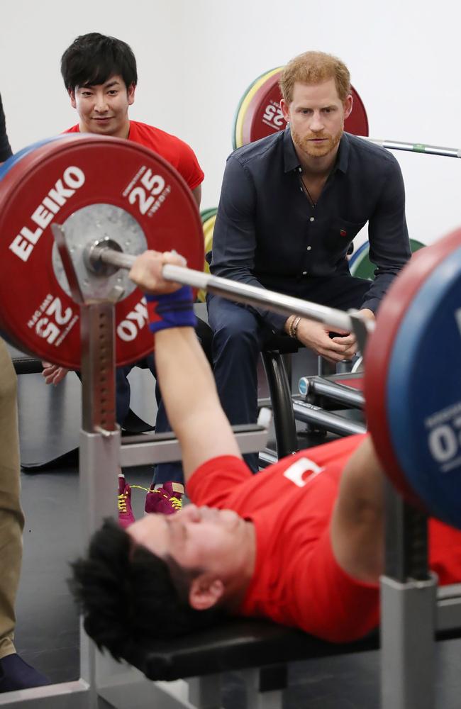 Britain’s Prince Harry watches a powerlifter during his tour of the Japan Foundation's Para Arena in Tokyo. Picture: AFP