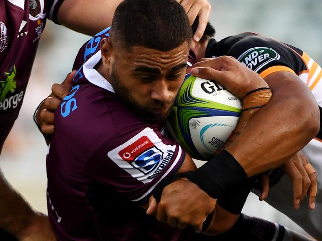 CANBERRA, AUSTRALIA - JANUARY 31: Lukhan Salakaia-Loto of the Reds is tackled during the round one Super Rugby match between the Brumbies and the Reds at GIO Stadium on January 31, 2020 in Canberra, Australia. (Photo by Tracey Nearmy/Getty Images)