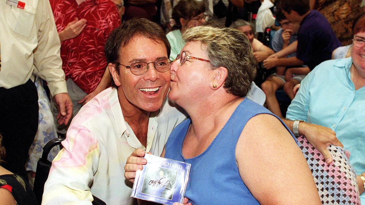 Cliff Richard at Toombul Shopping Centre in 2003 getting a kiss on the cheek from fan Ann Edwards.