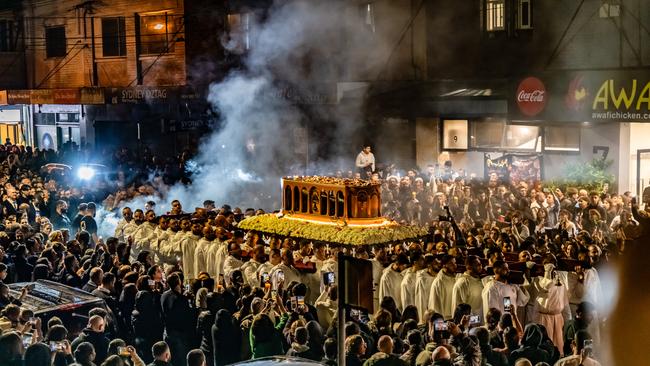 Thousands of Maronite Catholics braced the rain to join the street procession to St Charbel’s church. Picture: Giovanni Portelli Photography