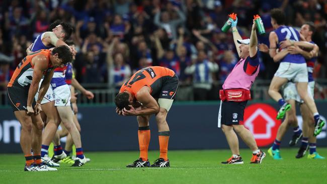 Shattered GWS players Ryan Griffen and Shane Mumford come to terms with the loss as Bulldogs players celebrate on the final siren. Picture: Phil Hillyard