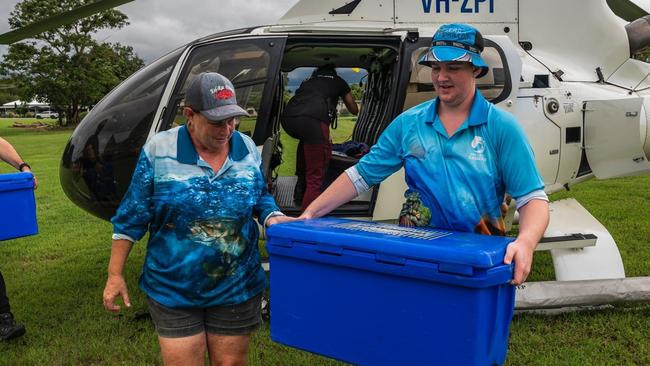 Floody legends Keldon Fletcher, 16, and mother Rae Moody unloading hot meals for distribution in Lucinda during the Hinchinbrook flood disaster. Picture: Supplied