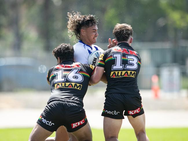 Xzavier Timoteo is tackled by Talmage Brown (left) and Cooper Flood. Picture: Julian Andrews