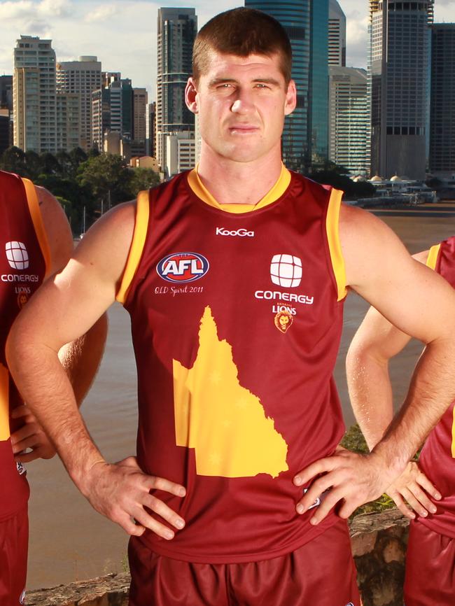 Jonathan Brown (middle) models a special Brisbane Lions ‘Queensland Spirit’ jumper worn in 2011.