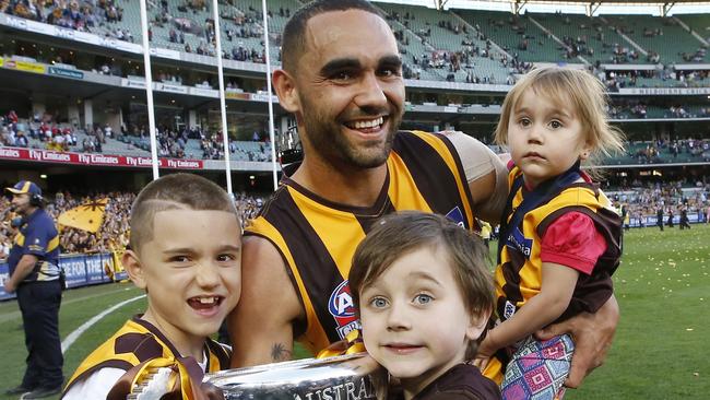 Hawthorn's Shaun Burgoyne holds the trophy with his children in 2014. Picture: David Caird