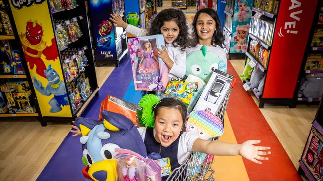 Ava, 5, Shanvi, 3, and Khushi, 9, are already in a shopping mood filling a trolley with toys. Picture: Jake Nowakowski