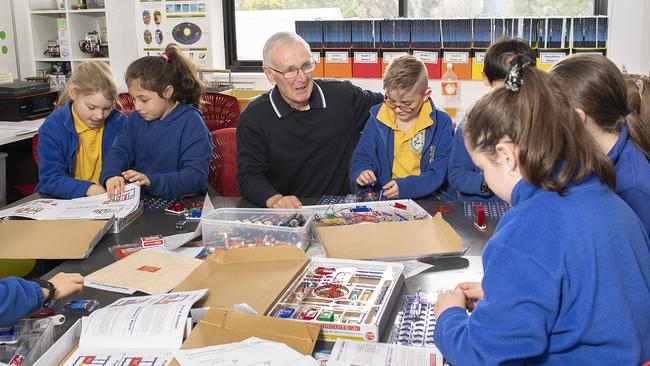 Teacher Peter Ruff has been recognised for his long service at Heidelberg Primary School. He's pictured with some Grade 3 students. Picture: Ellen Smith