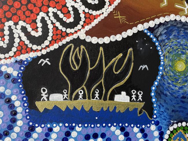 Part of a man's painting,  displaying a boat his ancestors used to travel across Northern Australia and into Asia on trading routes. Above is a section of Chris Gray's art which contains a ring of people (the 'U' shapes), representing Mates4Mates as a meeting place for everyone.