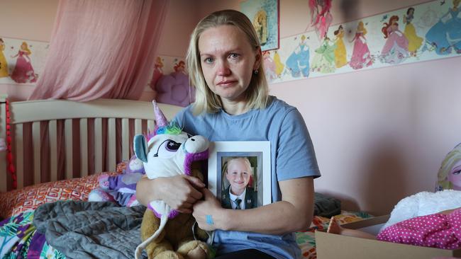 Yana Stevens on Olivia’s bed surrounded by her daughter’s favourite toys. Picture: David Caird