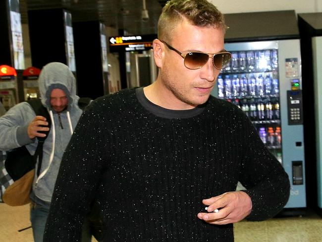 Michael Matthew and Ricky Longmuir arrive at Melbourne’s Tullamarine Airport after the midair fracas. Picture: Ian Currie