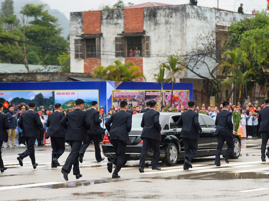 Kim Jong Un’s bodyguards run alongside his car as he leaves Dong Dang railway stationon the Vietnamese border, to attend the second US-North Korea summit in Hanoi. Picture: Nhac Nguyen / AFP