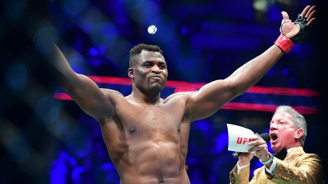 TOPSHOT - UFC 270 heavyweight world champion Cameroon's Francis Ngannou (C) reacts on introduction for fight against France's Ciryl Gane for the heavyweight title at the Honda Center in Anaheim, California on January 22, 2022. (Photo by Frederic J. BROWN / AFP)