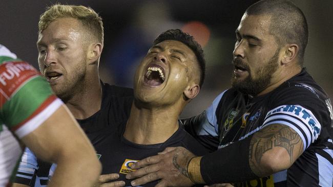 Fa'amanu Brown of the Sharks (centre) celebrates with Andrew Fifita (right) and Matt Prior after scoring a try.