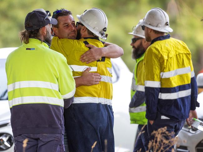 Miners embrace at the funeral service in Trentham. Picture: Mark Stewart