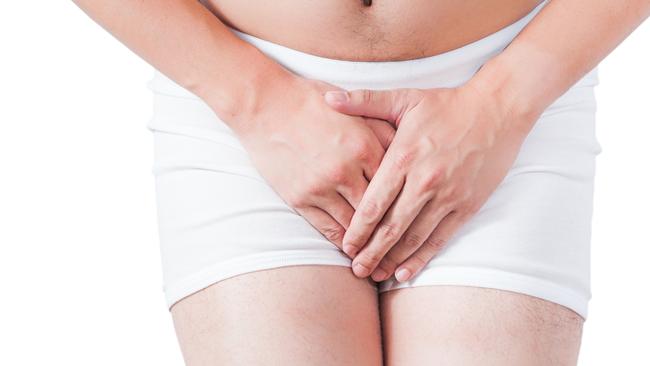 close up of shy man use hand to cover penis on white boxer underware isolate on white background