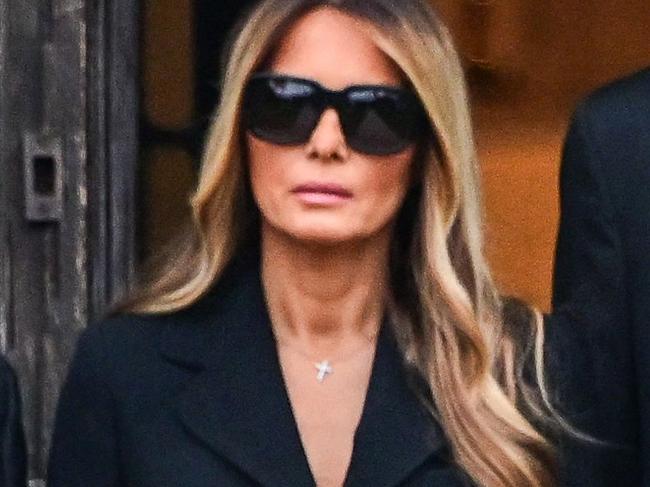 Former US President Donald Trump (R) stands with his wife Melania Trump (2L) their son Barron Trump (C) and father-in-law Viktor Knavs, at the start of a funeral for Amalija Knavs, the former first lady's mother, in Palm Beach, Florida, on January 18, 2024. Former first lady Melania Trump's mother Amalija Knavs, 78, died January 9, 2024 in Miami following an undisclosed illness. (Photo by GIORGIO VIERA / AFP)