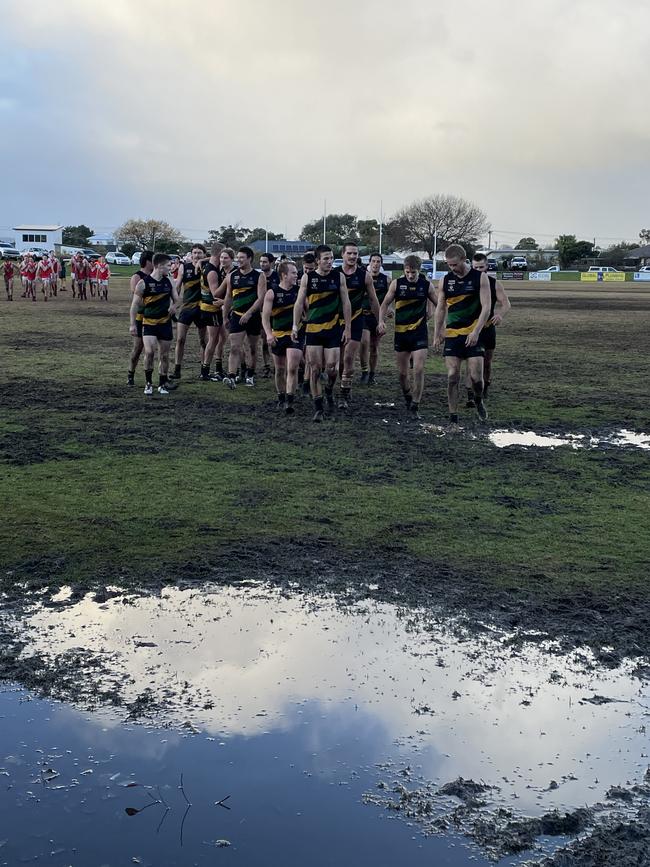 Dromana players leave a muddy and wet ground.