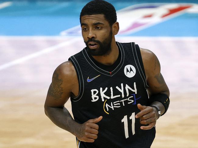 (FILES) In this file photo taken on December 27, 2020 Kyrie Irving #11 of the Brooklyn Nets runs the court during the fourth quarter of their game against the Charlotte Hornets at Spectrum Center in Charlotte, North Carolina. - Brooklyn point guard Kyrie Irving, who has been staunchly against getting vaccinated for the coronavirus, missed the Nets' practice on October 5, 2021. (Photo by Jared C. Tilton / GETTY IMAGES NORTH AMERICA / AFP)