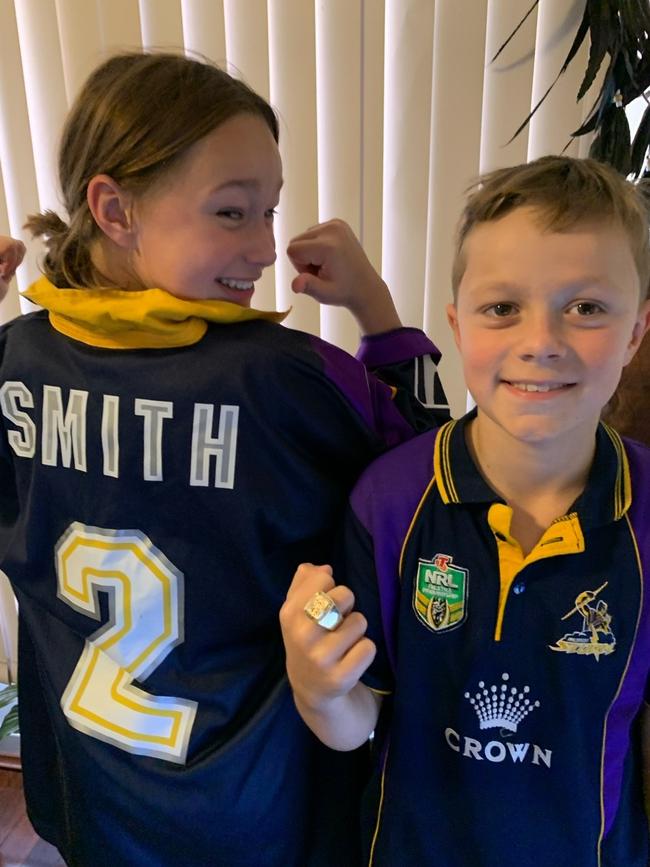 Craig’s kids Bella and Jack Smith with one of the two jerseys from the 1999 grand final day and the premiership ring. The ring was later stolen from a safe.