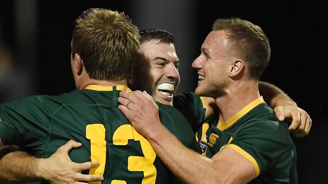 James Tedesco of the Kangaroos celebrates his try with team mates Jake Trbojevic and Daly Cherry-Evans after scoring a try during the Oceania Cup Test Match between Australia and New Zealand at WIN Stadium in Wollongong, Friday, October 25, 2019. (AAP Image/Dean Lewins) NO ARCHIVING, EDITORIAL USE ONLY