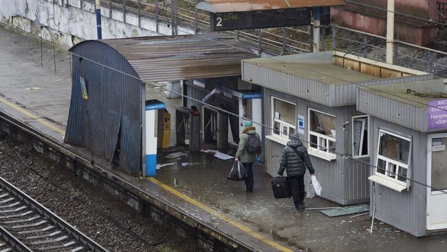 Local residents walk pass a damaged train station in Kyiv, Ukraine. Photo: Pierre Crom/Getty Images