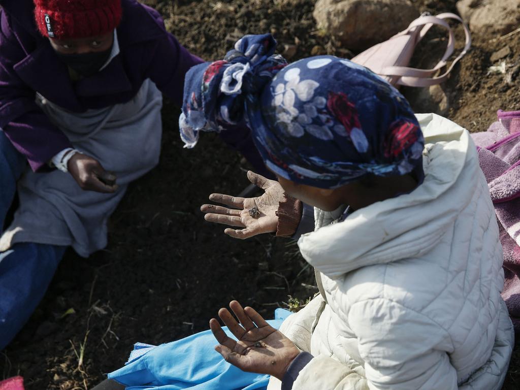 A woman with what she believes to be a diamond at KwaHlathi village. Picture: Phill Magakoe/AFP