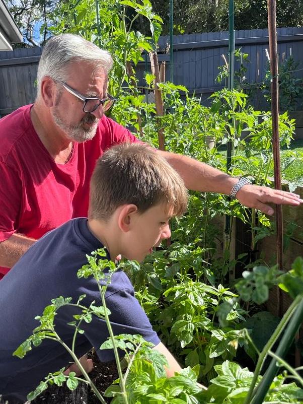 Uncle Joe sharing the joy of the garden with his grandson, Oskar.