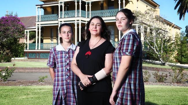 Amanda Gardiner with daughters Alice, 13, and Virginia, 15, at Domremy Catholic College in Sydney yesterday. John Feder.