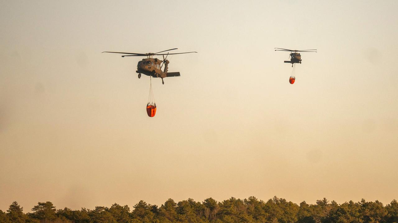 A rescue helicopter picks up water at Wild Wood Lake on March 8, 2025 in Westhampton, New York. Picture: Andrew Theodorakis/Getty Images/AFP