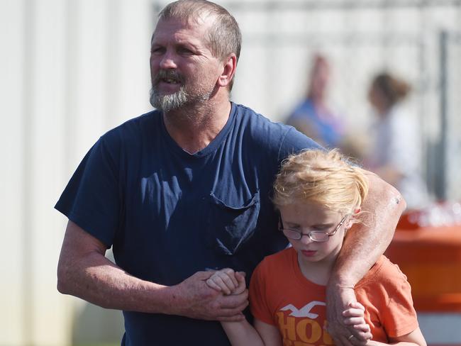 Joey Taylor walks with his daughter Josie Taylor after the shooting. Picture: AP