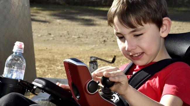 A new wheelchair has finally arrived for nine-year-old, Angus Hopkins. The long awaited delivery on Sunday will be a life changer for the boy from Nobby. Angus takes control of his new wheelchair. June 2019. Picture: Bev Lacey