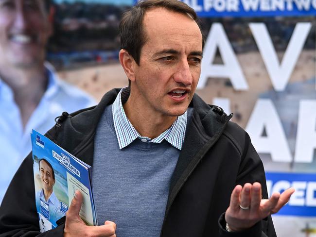 Liberal member for Wentworth Dave Sharma speaks to voters during Australia's general election at a polling station at Bondi Beach in Sydney on May 21, 2022. (Photo by STEVEN SAPHORE / AFP)