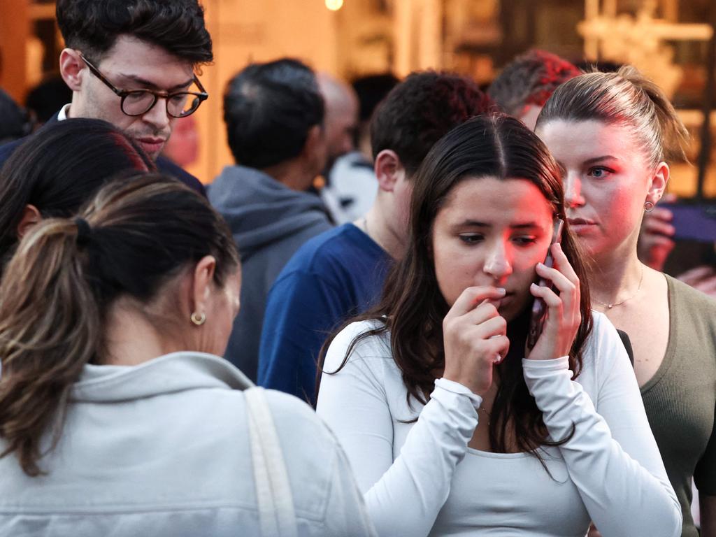 People react outside the Westfield Bondi Junction shopping mall after a stabbing incident. Picture: David GRAY / AFP