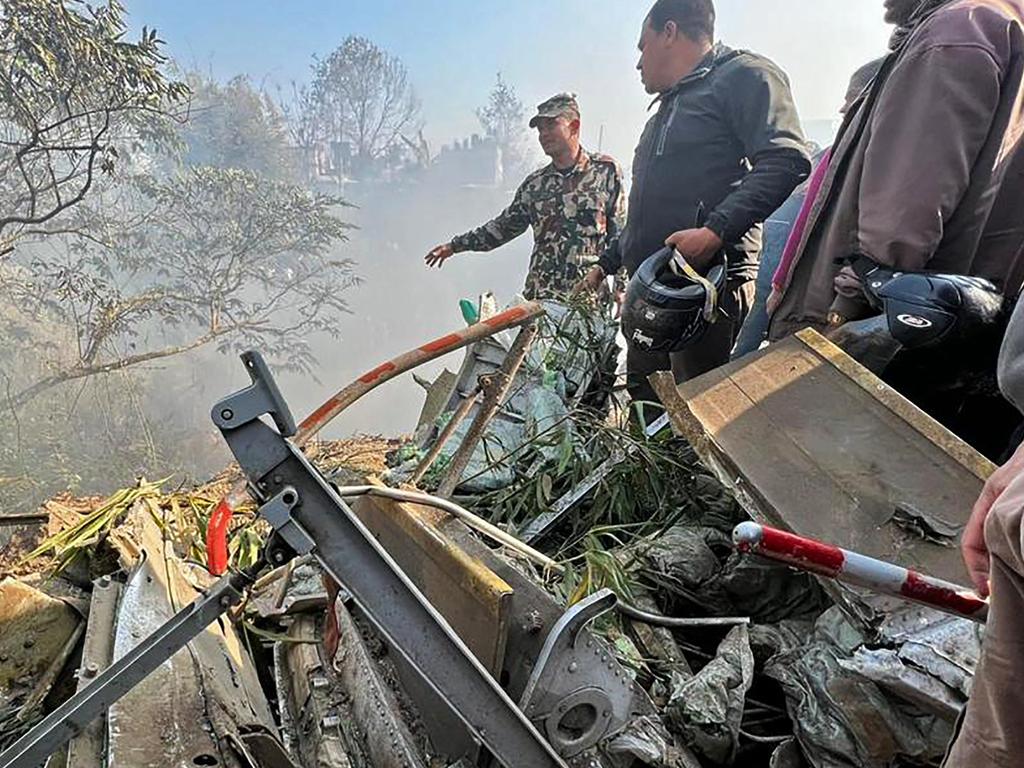 Rescuers gather at the site of the plane crash in Pokhara. Picture: Krishna Mani Baral / AFP