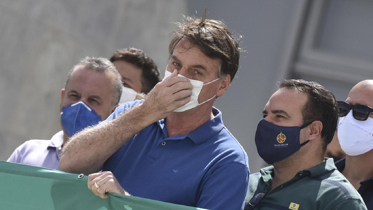 Brazil's President Jair Bolsonaro, wearing a protective face mask as a precaution against the spread of the new coronavirus. Picture: AP/Andre Borges)