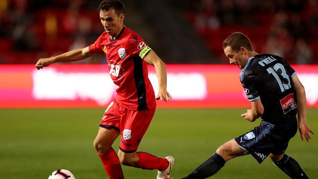 Isaias of Adelaide United finds a path past Brandon O'Neill of Sydney FC on Friday night. Picture: James Elsby/Getty Images