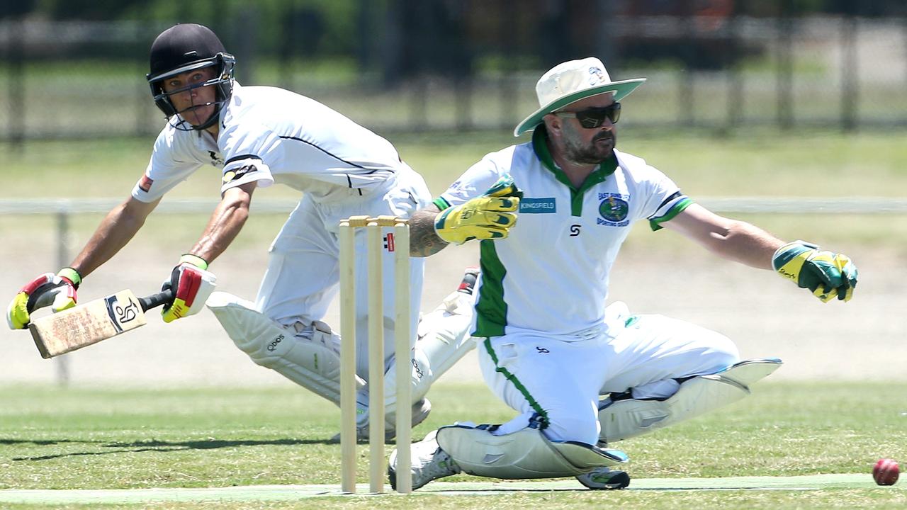 GDCA - Diggers Rest Bulla’s Jordon McDonald dives for his crease as East Sunbury keeper Lance Watts reaches for the ball. Picture: Hamish Blair