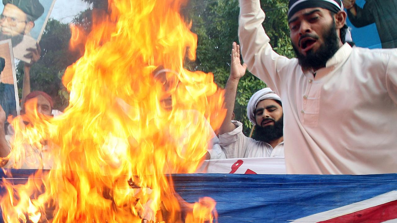 Pakistani Muslims torch a British flag in 2007 to condemn Rushdie’s knighthood. Picture: Arif Ali/AFP