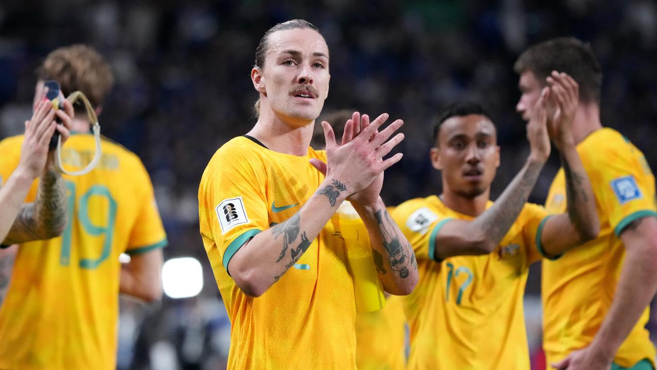 Jackson Irvine (centre) and Keanu Baccus thank Socceroos fans after the team’s 1-1 draw with Japan. Picture: Koji Watanabe/Getty Images