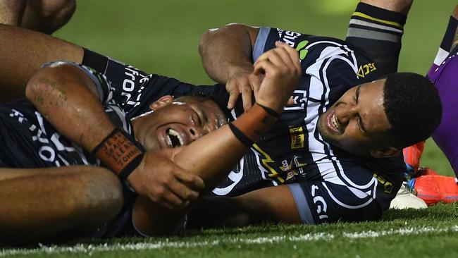 John Asiata and Nene Macdonald lie on the ground in pain after colliding on Friday night. Picture: Ian Hitchcock/Getty Images