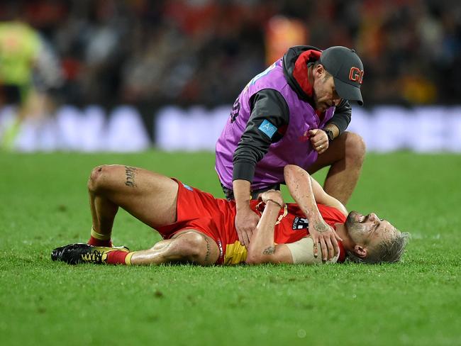 Suns star Izak Rankine receives attention on his injured shoulder. Picture: Matt Roberts/Getty Images