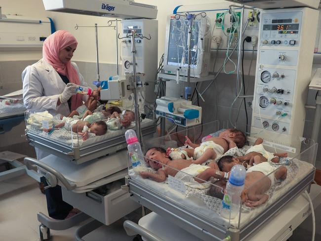 A Palestinian medic cares for premature babies, evacuated from Gaza City's Al Shifa hospital, ahead of their transfer from a hospital in Rafah in the southern Gaza Strip to Egypt. Picture: AFP