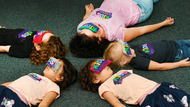 KIDS IN HARMONY; Well Being Educator Kate Martyn with Theo Penna 4, Grace and Eliose Davison 4 and Ella Church 3. Picture: Alix Sweeney