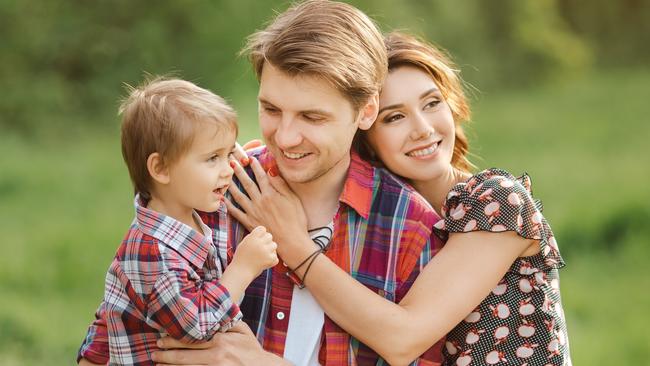 Happy Family on the nature. Mother father and son in casual clothes, sit on a fence, rural look , outdoors; life insurance generic happy family