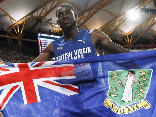 British Virgin Islands’ Kyron Mcmaster celebrates winning the athletics men's 400m hurdles final during the 2018 Gold Coast Commonwealth Games at the Carrara Stadium on the Gold Coast on April 12, 2018. / AFP PHOTO / Adrian DENNIS