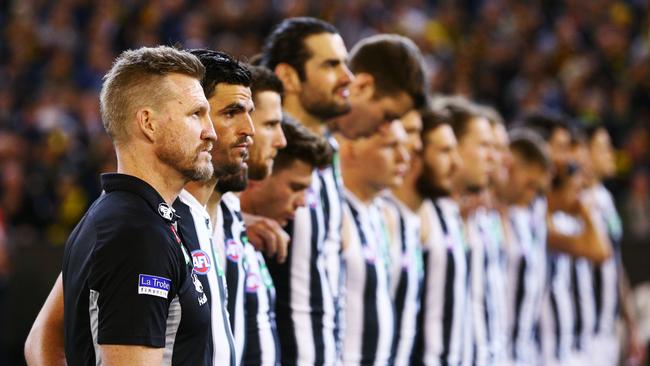 Magpies head coach Nathan Buckley lines up for the national anthem with his Collingwood charges on Friday night. Picture: Michael Dodge/AFL Media/Getty Images